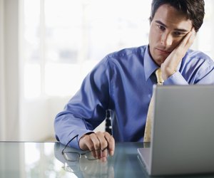 Frustrated businessman with laptop computer