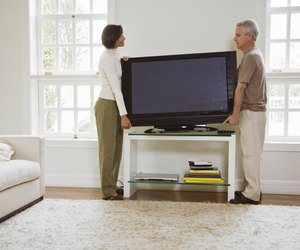 Couple moving flat screen television