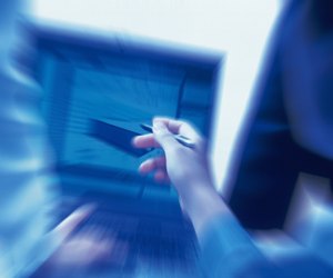 Photography of Three people working together with a computer at the desk, Portrait, Rear View, Toned Image, Blurred Motion