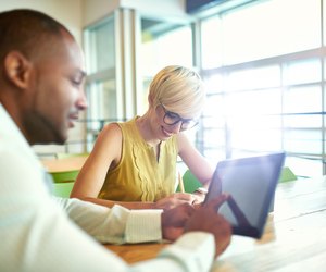 Two creative millenial small business owners working on social media