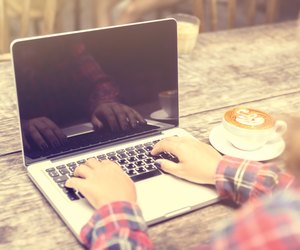 Girl with laptop and cup of coffee, vintage photo effect