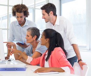 Workers looking at a presentation on the computer