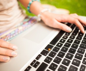 Detail shot of a woman using laptop