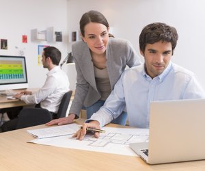 Business team working on laptop in office