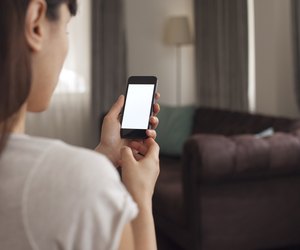 Woman using a smartphone in a living room