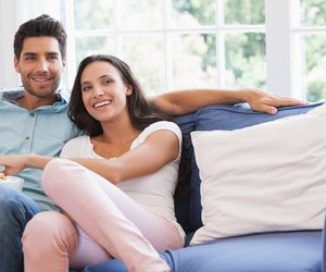 Attractive couple watching tv on the couch