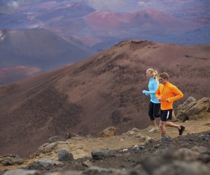 Fitness sport couple running jogging outside on trail