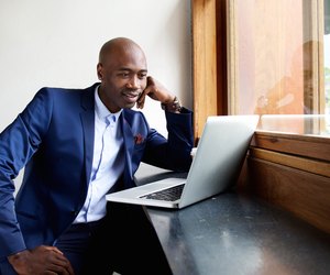 Businessman at a cafe looking at laptop
