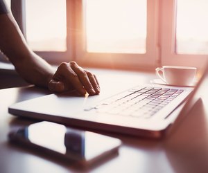 Male hand on laptop keyboard