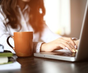 Closeup of a female hands busy typing on a laptop