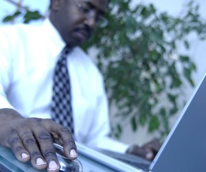 A mid adult businessman working on a laptop computer
