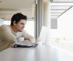 Man using laptop computer in cafe