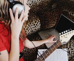 Woman wearing headphones composing song