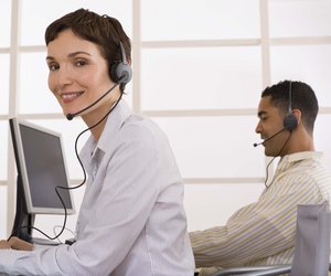 Businesspeople using handsfree headset telephone