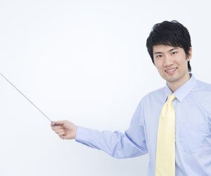Portrait of businessman holding pointer stick, China, Beijing