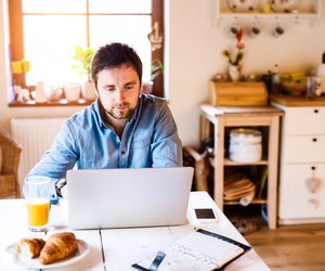 Man sitting at desk working from home on laptop