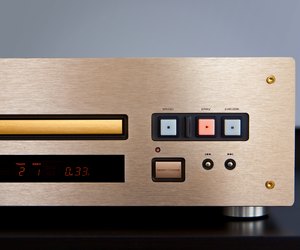 Expensive CD Player Playing Music with Golden Front Panel