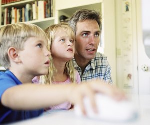 Father and children playing computer