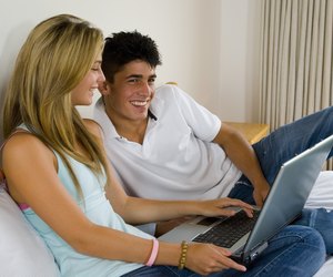 Teenagers doing homework with laptop computer