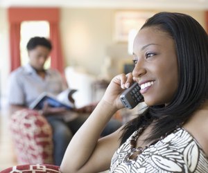 Close-up of a young woman talking on a cordless phone