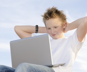 Fair-haired schoolboy relaxing hands behind his head