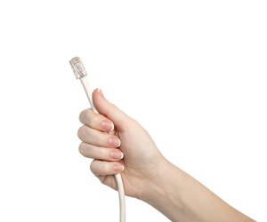 isolated woman hand holding a computer cable
