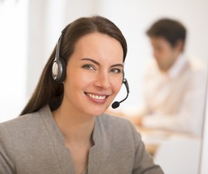 Beautiful Businesswoman in the office on the phone, headset