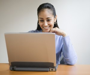 Young adult smiling with computer