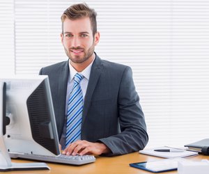 Young businessman using computer at office desk