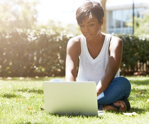 Young attractive dark-skinned college student wearing tank top