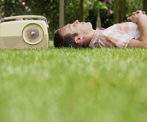 Man relaxing on lawn with old-fashioned radio