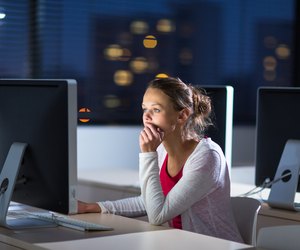 Pretty, young female college student using a desktop computer/pc