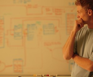 Man analyzes workflow chart