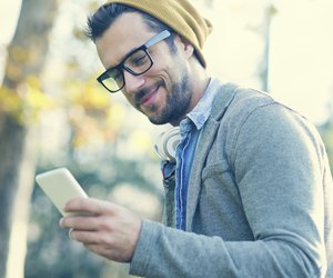 handsome man typing text message