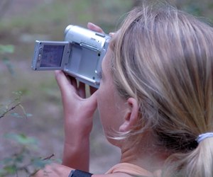 Rear view of a girl using a home video camera