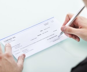 Businessman Signing On Cheque