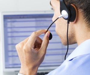 man wearing headset looking at monitor