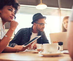 Young friends at a coffee shop with laptop