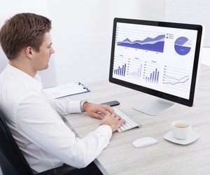 Young Businessman Using Computer At Desk