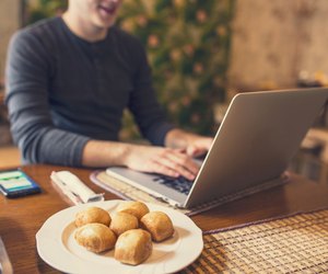 Man sitting in chinese restaurant and working on his laptop