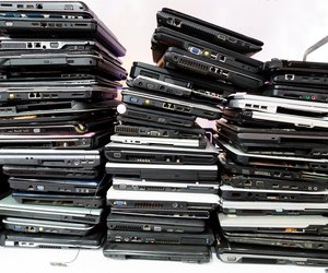 Stack of old, broken and obsolete laptop computer