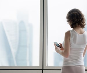 Young woman using smartphone indoors