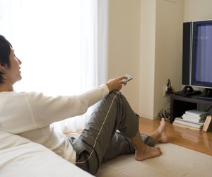 Man sitting on floor and watching TV