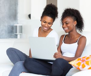 African American student girls using a laptop computer