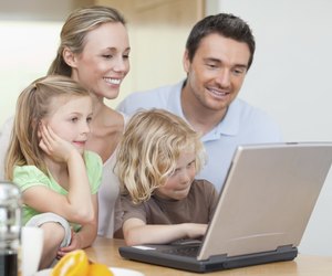 Family using their laptop in the kitchen