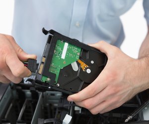 Hands fixing cable to hard disk