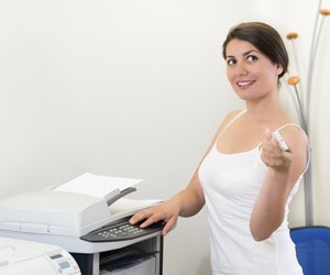 Young business woman making copies