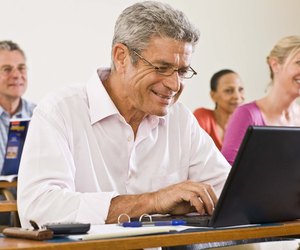 Man using laptop computer in classroom
