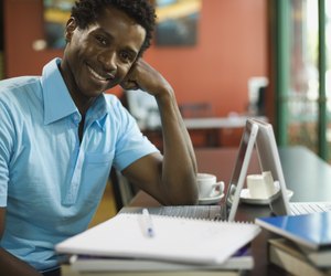 Smiling man with laptop computer