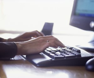 Woman's hands typing on computer keyboard